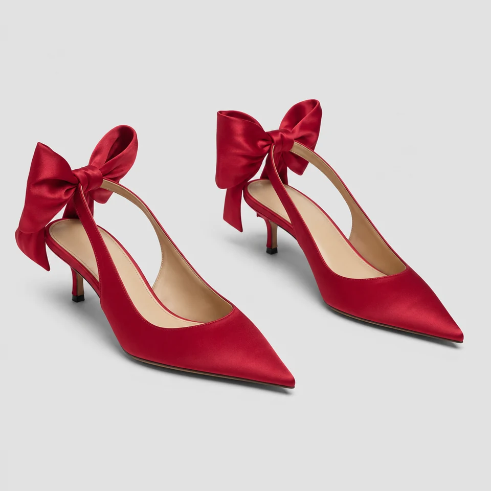 Red satin-look slingback pumps with pointed toes, low stiletto heels, and large bows on the ankle straps