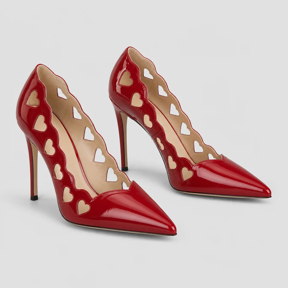 Glossy red pointed pumps with scalloped edges and heart-shaped cutouts along the topline