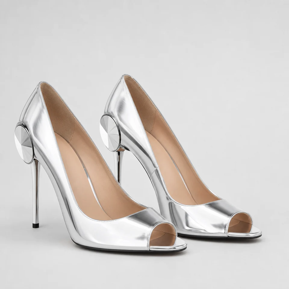 Silver metallic-look peep-toe pumps with sculptural circular accent on stiletto heel