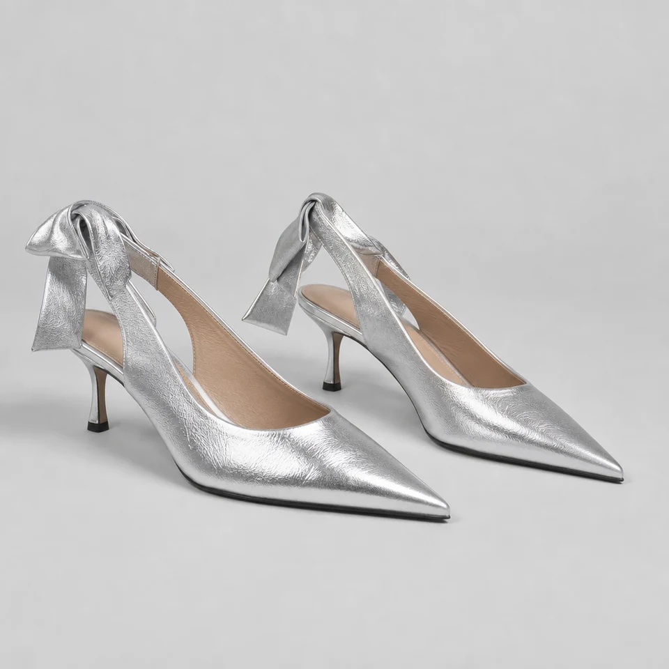 Silver metallic-look pointed toe slingback pumps with knot accent and low stiletto heel