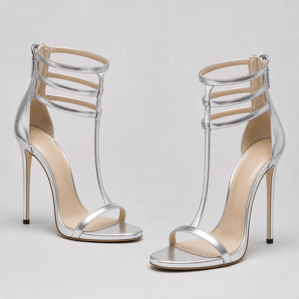 Pair of silver metallic look high stiletto sandals with T-strap and triple ankle straps