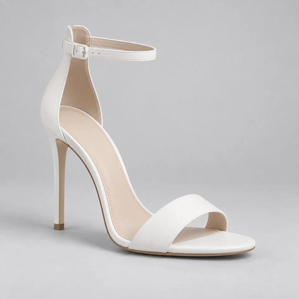 White single strap ankle strap stiletto sandal with glossy finish on light gray background